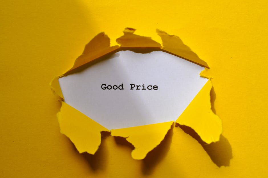 A close-up image of a torn yellow paper covering a white note with the words 'Good Price' typed in black ink, revealing the message through the irregular tear in the paper. The torn edges are jagged and curling outward, casting subtle shadows on the yellow background. The paper appears to be part of a larger card or poster, with the focus on the message suggesting affordability or value, which could relate to private waste management or alternative rubbish removal services provided by Rubbish Clearance Islington. The lighting is even, emphasizing the contrast between the bright yellow surface and the white note, with slight reflections visible on the torn paper edges, capturing a clean, professional presentation suitable for service-related content around rubbish clearance prices.
